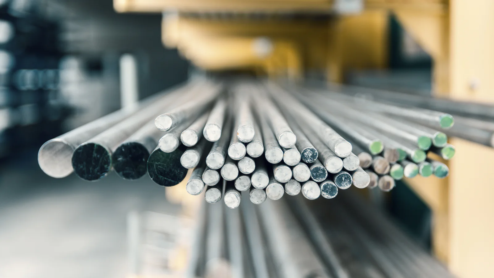 Clean small-diameter round steel bars aligned for industrial processing